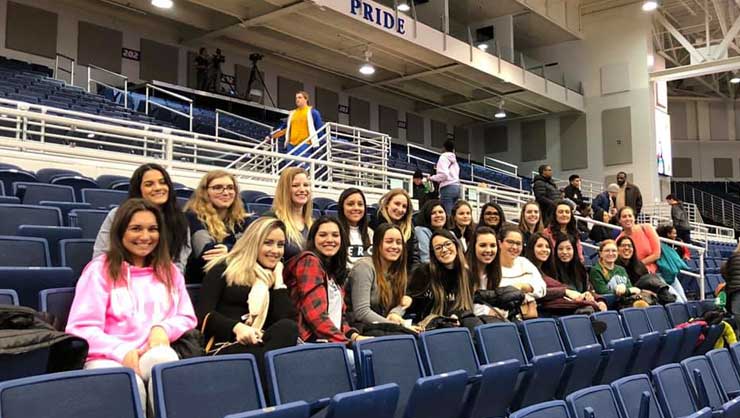 Image courtesy of Jill DeMarco Au pairs in Long Island cheered on the women’s basketball team at Hofstra University.